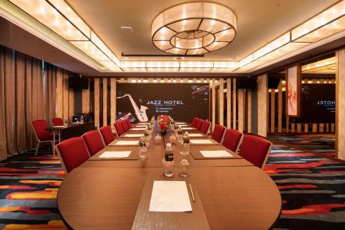 a conference room with a long table and red chairs at Jazz Hotel Penang in George Town