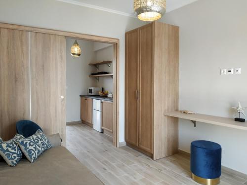 a living room with wooden cabinets and a kitchen at Lilly Apartments in Athens