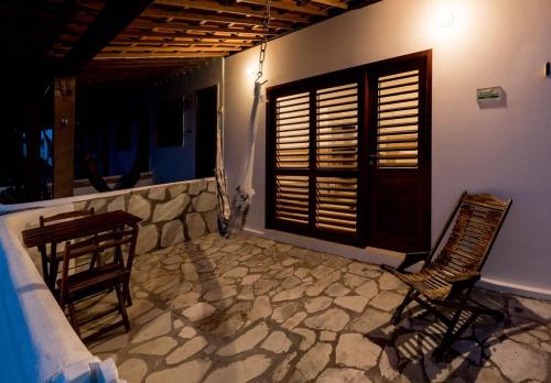 a room with a table and chairs and a window at Pousada Brésil Aventure in Galinhos