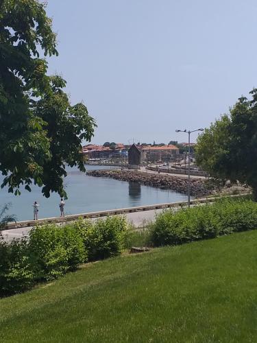 a person riding a bike on a path next to a river at Nirvana Guest House in Nesebar