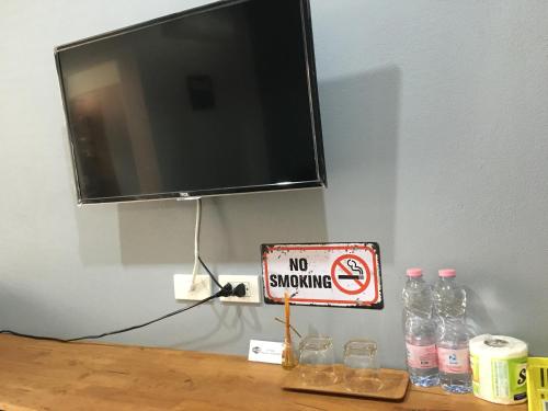 a no smoking sign and a no smoking sign on a table at SP Home BangSaen in Bangsaen