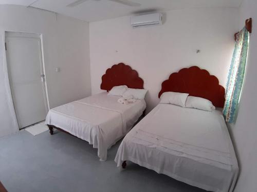 Postel nebo postele na pokoji v ubytování Habitaciones Chiquil Ha