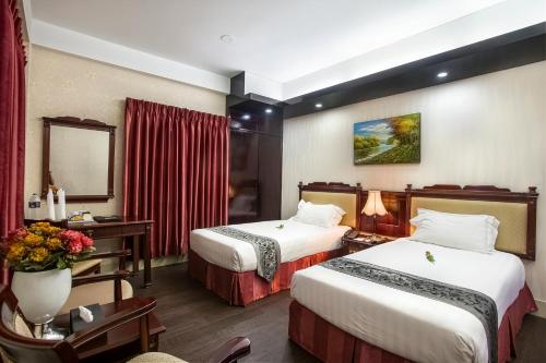 Llit o llits en una habitació de Hotel Highgarden