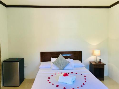a bedroom with a bed with a cake on it at Chekesh Casa in Siquijor
