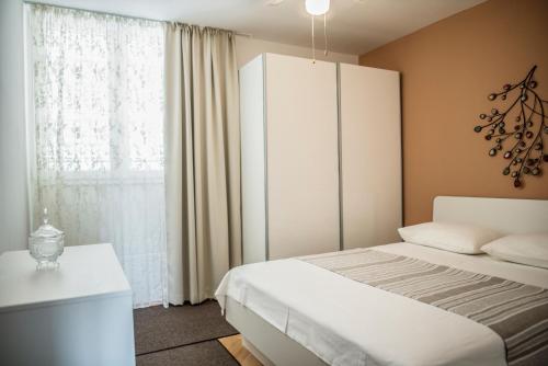 a bedroom with a bed and a large window at Apartment Beach in Omiš