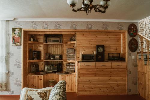 a large wooden book shelf in a room at Ismayilli Guest House in İsmayıllı