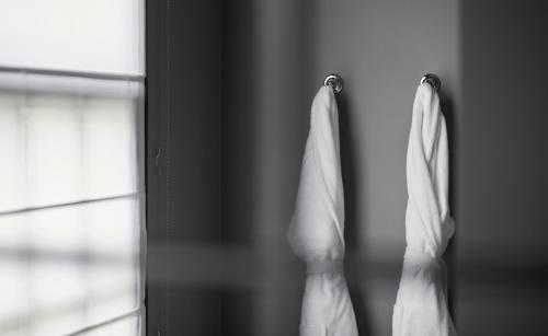 a towel hanging on a door next to a window at Hotel Odette en Ville in Brussels
