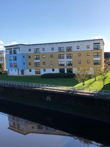 a large building next to a body of water at ArcView - SEC Hydro Two Bed Flat With Free parking and Great View in Glasgow