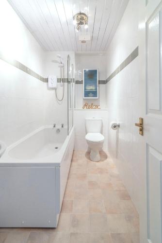 a bathroom with a tub and a toilet and a shower at ArcView - SEC Hydro Two Bed Flat With Free parking and Great View in Glasgow