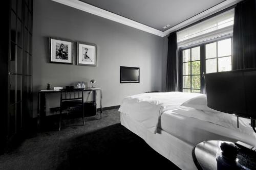 Postel nebo postele na pokoji v ubytování Hotel Odette en Ville