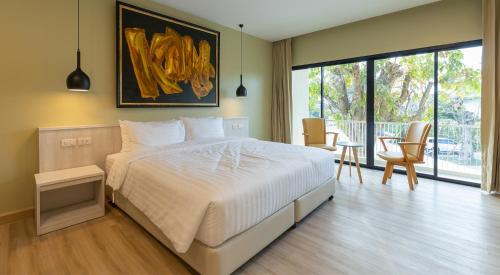 Postel nebo postele na pokoji v ubytování Porestva Hotel Sriracha