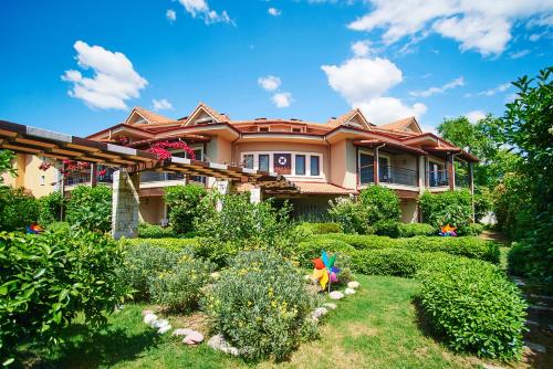 a house with a garden in front of it at Renka Hotel & Spa in Göcek