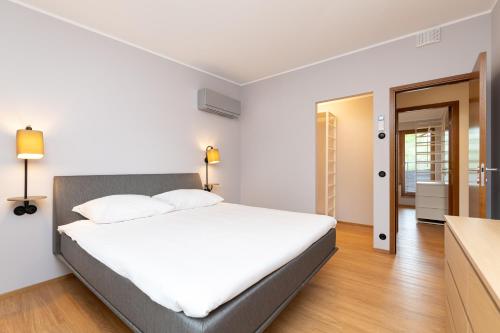 a bedroom with a large white bed in a room at Self-check-in 3 bedroom apartment with sauna and balconies in Tallinn
