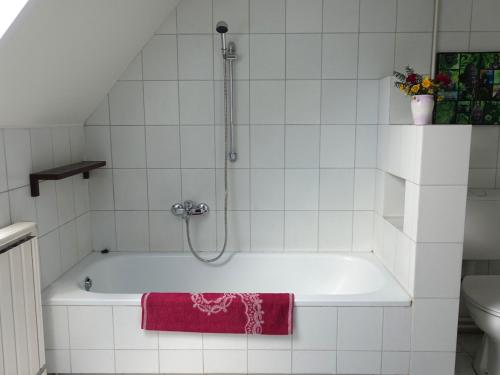 a bathroom with a bath tub with a shower at Family room for 4-6 person in Budapest