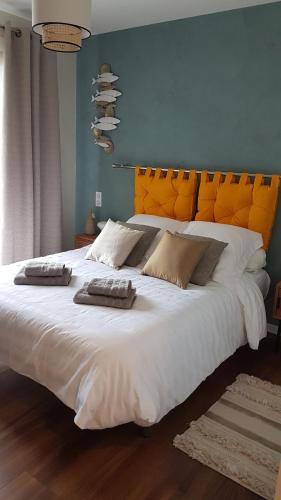 a large white bed with two towels on top of it at Apartment Cap Ostrea in Andernos-les-Bains