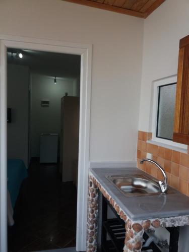 a kitchen with a sink in a room at Qeparo Antonio Rooms in Qeparo