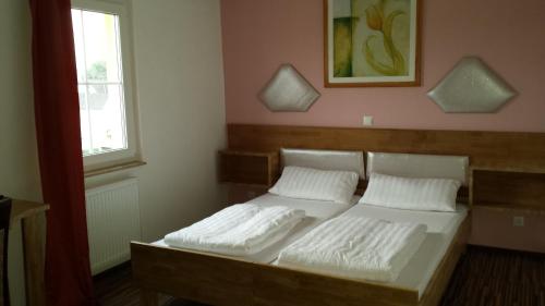 a bedroom with two beds and a window at Hotel La Terrazza in Wetzlar