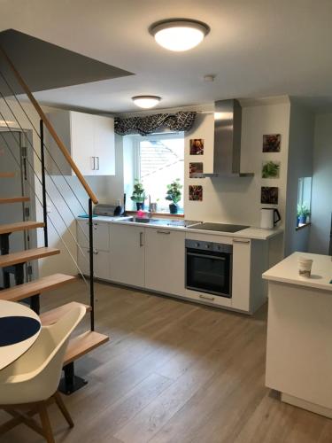 a kitchen with a sink and a stove top oven at The White House in Bergen