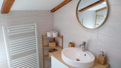 a bathroom with a sink and a mirror at Hiša Kala in Kobarid