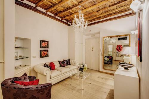 a living room with a couch and a chandelier at Portico D'ottavia in Rome