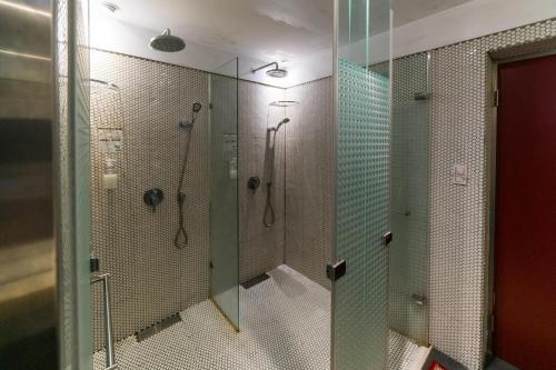 a bathroom with two shower stalls with glass walls at Gs Gay Hotel - Taipei in Taipei