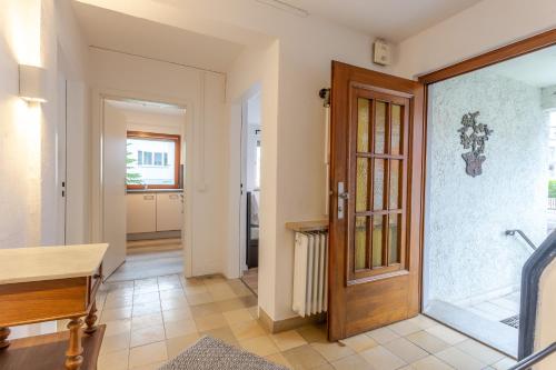 a hallway with a wooden door in a house at city-house-bühl in Bühl