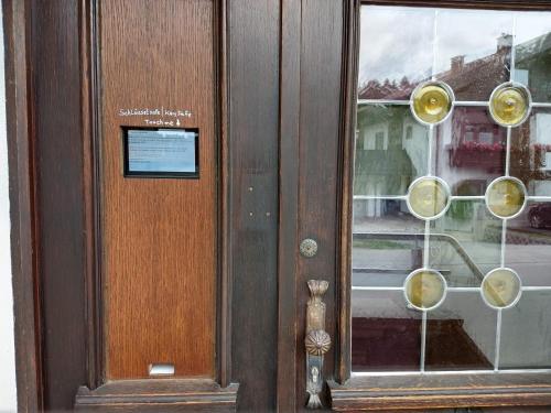 a wooden door with a bunch of wine glasses at Pension Handle in Kramsach