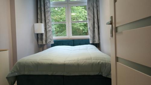 Posteľ alebo postele v izbe v ubytovaní Apartament 4 przy Parku Leśnym