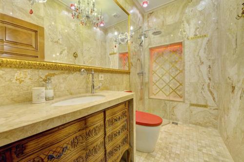 a bathroom with a sink and a shower at Luxury Pilies Avenue Apartment in Vilnius