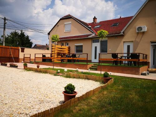 a house with a yard with potted plants at Green Garden Plus Apartman in Budapest