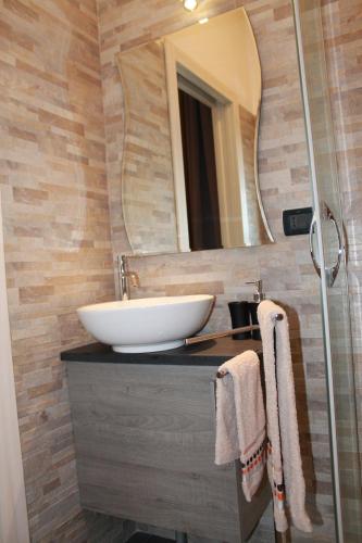 a bathroom with a sink and a mirror at Il Roseto di Daniela in Montefiascone