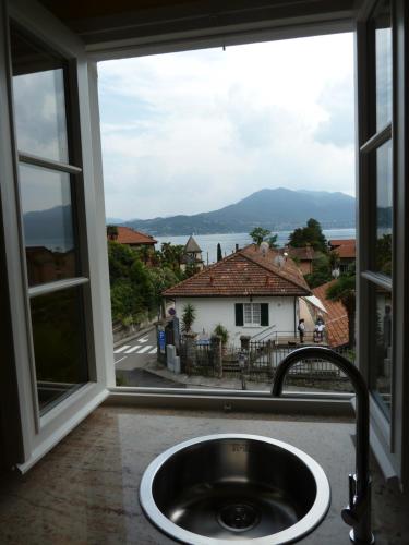 a sink in front of a window with a view at Forster's Nest in Cannero Riviera