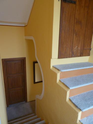 a hallway with stairs and a door in a house at Forster's Nest in Cannero Riviera