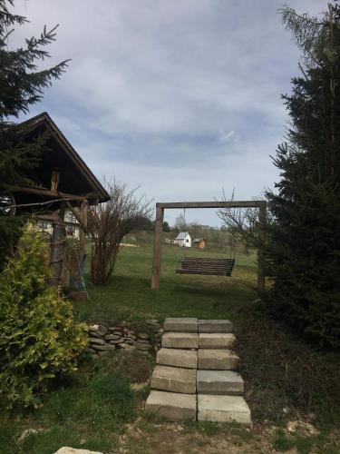 a park with a bench and a stone path at Apartament 212 in Klikuszowa