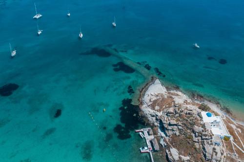 an aerial view of a beach with boats in the water at Bohemian Luxury Boutique Hotel, Adults Only in Naousa