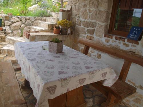 a table with a table cloth on top of it at konoba in Rab