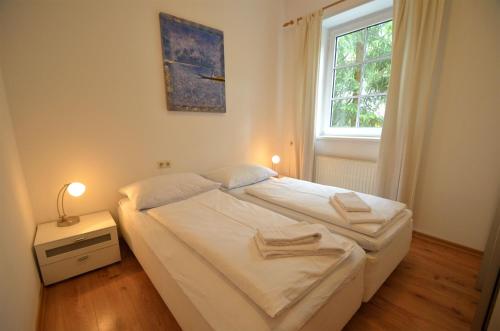 a small bedroom with a bed and a window at Apartment CityXpress TOP 6 by All in One Apartments in Zell am See