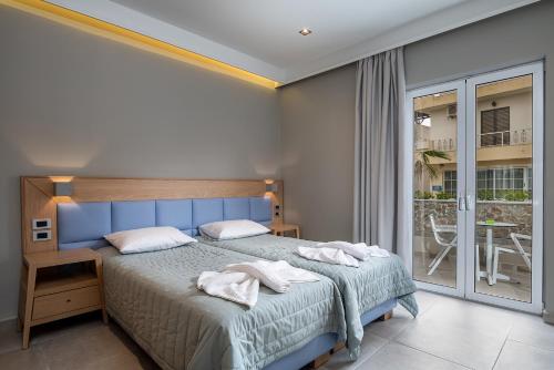 ein Schlafzimmer mit einem Bett mit zwei Handtüchern darauf in der Unterkunft Argiri Resort Hotel & Apartments in Kardamaina