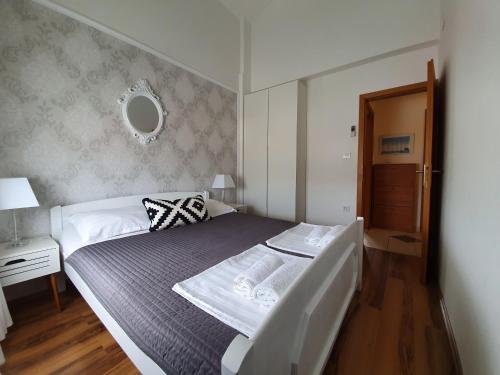 a bedroom with a bed and a table and a mirror at Apartment Marta in Pag