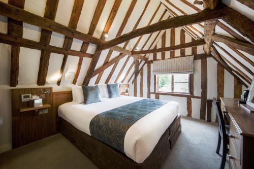 a bedroom with a large bed in a attic at The Oaksmere in Eye