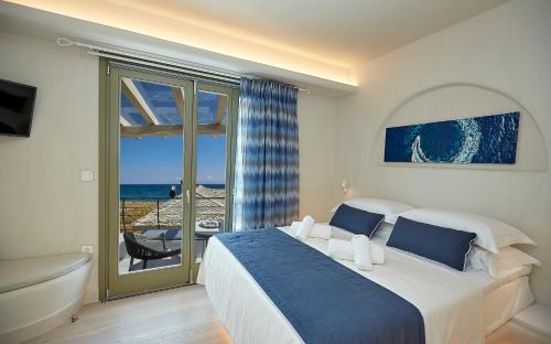 a bedroom with a bed and a view of the ocean at Sunrise Pelion Sea View Villas in Chorefto