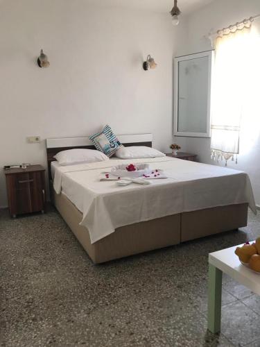 a bedroom with a large bed with flowers on it at Halikarnas Pansiyon in Bodrum City