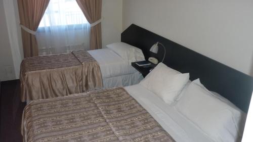 Katil atau katil-katil dalam bilik di Apart Hotel Austral