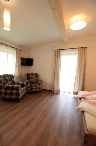 a living room with two chairs and a couch at Pension Tannenhof in Leogang