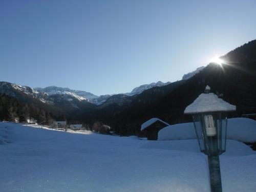 a light pole in the snow with mountains in the background at Maso Pin in Madonna di Campiglio