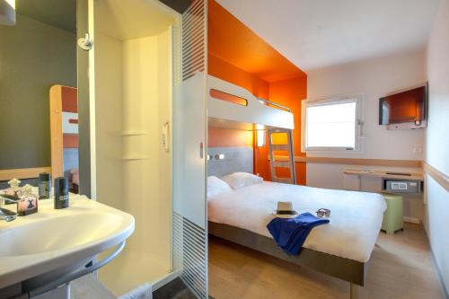 a hotel room with a bed and a sink at ibis budget Marseille L'Estaque in Marseille