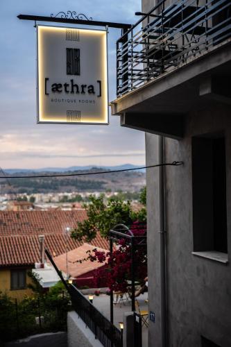 a sign for a leettera restaurant on the side of a building at Aethra Boutique Rooms in Nafplio