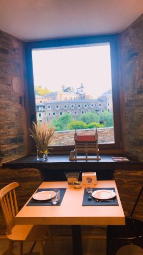 a table in a room with a large window at A Casa da Botica in Samos