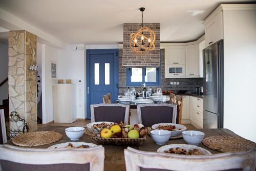 a kitchen with a table with fruit on it at Villa LeSunLuka Lefkada in Vasiliki