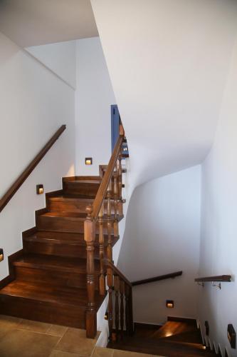 a staircase in a house with wooden stairs at Villa LeSunLuka Lefkada in Vasiliki